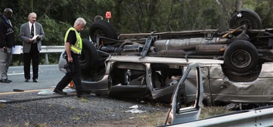 State police investigate the scene of a fatal accident on Sept. 18 in Woodbury, N.Y. A passenger van carrying members of a church flipped over on the New York State Thruway, killing at least six people and injuring eight others, authorities said.